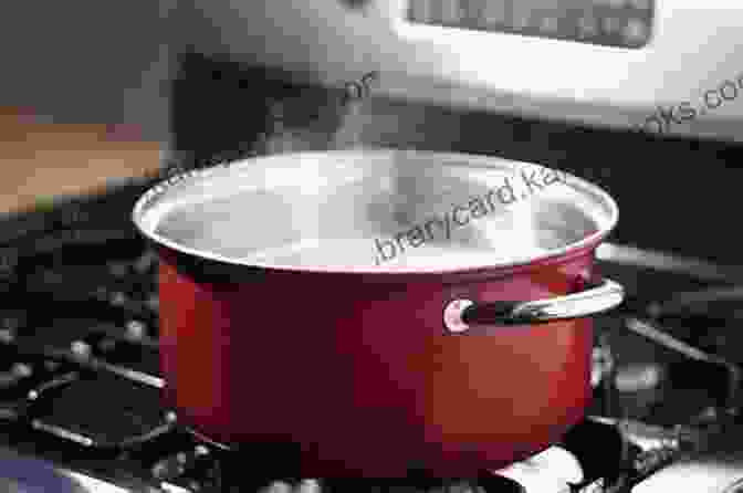 A Person Removing A Pot Of Boiling Water From The Stove How To Boil Water C Wade Coldiron