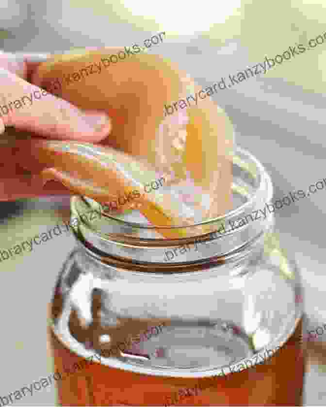 A Vibrant Image Of A Woman Brewing Kombucha In A Home Kitchen, With SCOBY And Fermentation Equipment Visible Green Tea: All About The Miraculously Healthy Drink Its Many Variations And History (Worlds Most Loved Drinks 9)